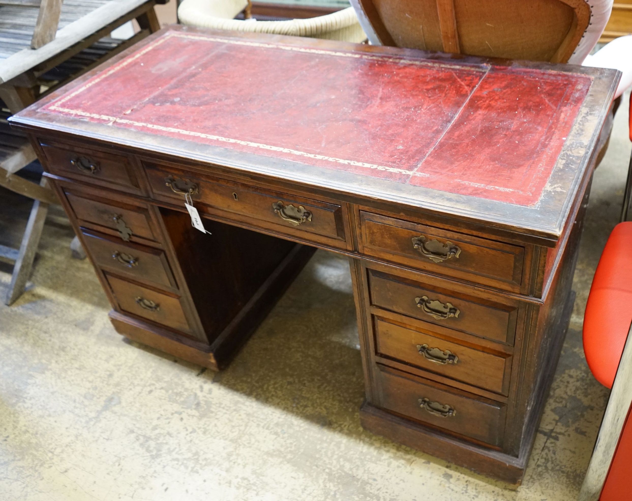 An early 20th century nine drawer writing desk, width 122cm depth 57cm height 75cm